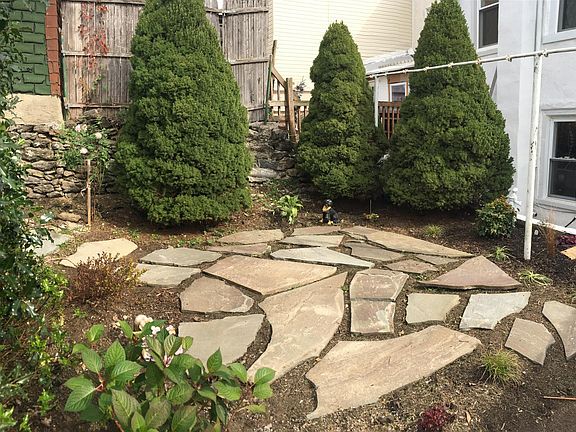 Landscaped backyard with bluestone patio