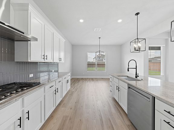 The kitchen has sprawling granite countertops.