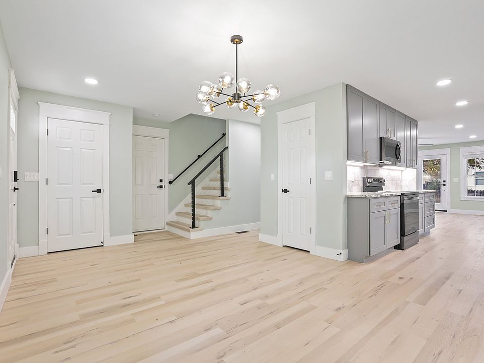Dining room/entryway. The open-concept layout is evident by being able to see the dining room, kitchen, and living room in one photo.