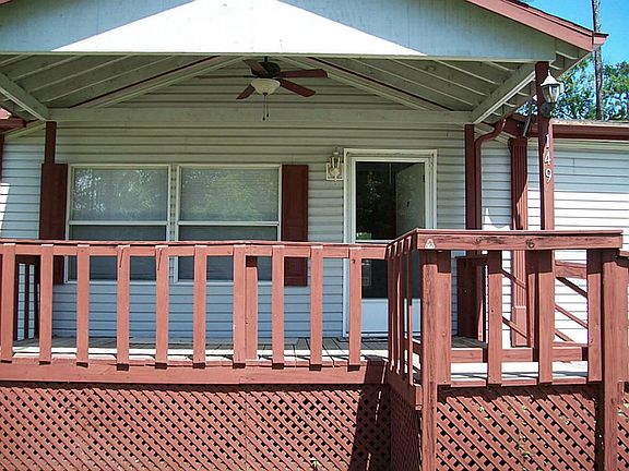 Front entrance of home features covered porch with ceiling fan which has a remote control.