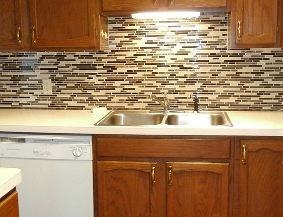 The kitchen has newer appliances and new glass backsplash.