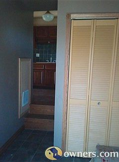 Inviting Entry with Oak Stairs and Ceramic