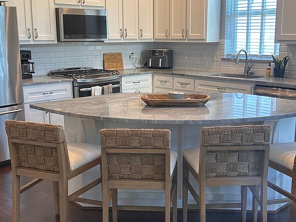 Four comfortable, stylish stools aligned at countertop