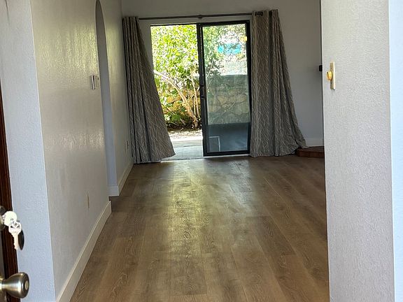 Front entrance looking to living room and view to private back patio
