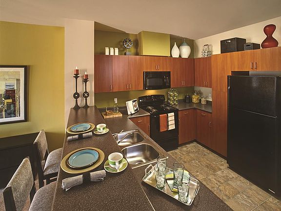 Kitchens featuring sleek black GE appliances and granite ins