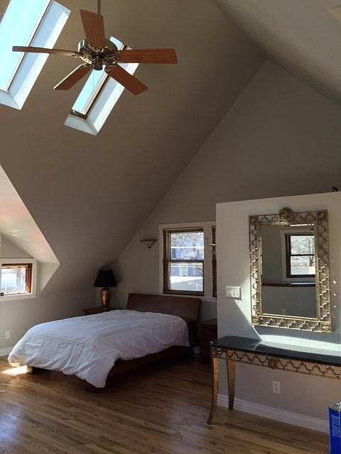 Queen size bed, vaulted ceiling with skylights and ceiling fan