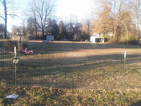 Fenced in back yard/shed