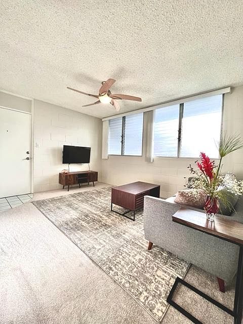 Living Room has jalousie windows and blinds