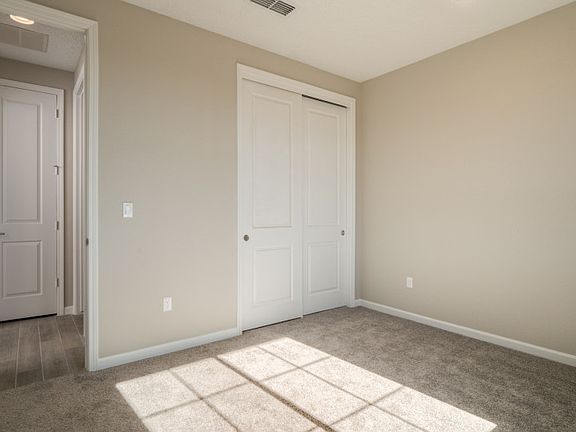 Additional downstairs bedroom also includes a functional closet space.