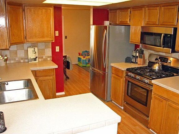 Totally update kitchen with warm oak cabinets, new countertops, new stainless sink, new flooring, & 