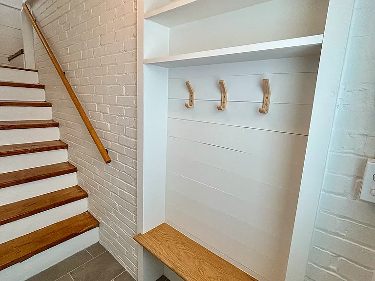 Entry. Built in coat rack, shelves and bench.