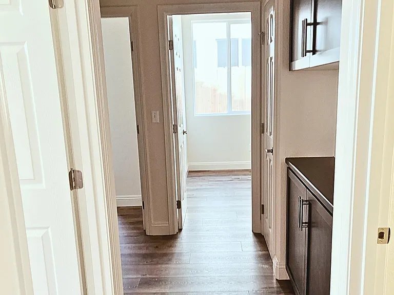 Hall: Main bath, linen closets, inside laundry room, main bath and secondary bedrooms