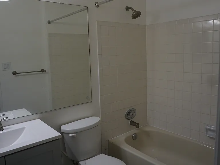 Full bathroom with updated cabinets.