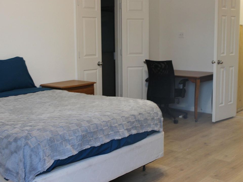 Queen Bed with Desk, Dresser, Closet, Lamp, and Mini-Fridge