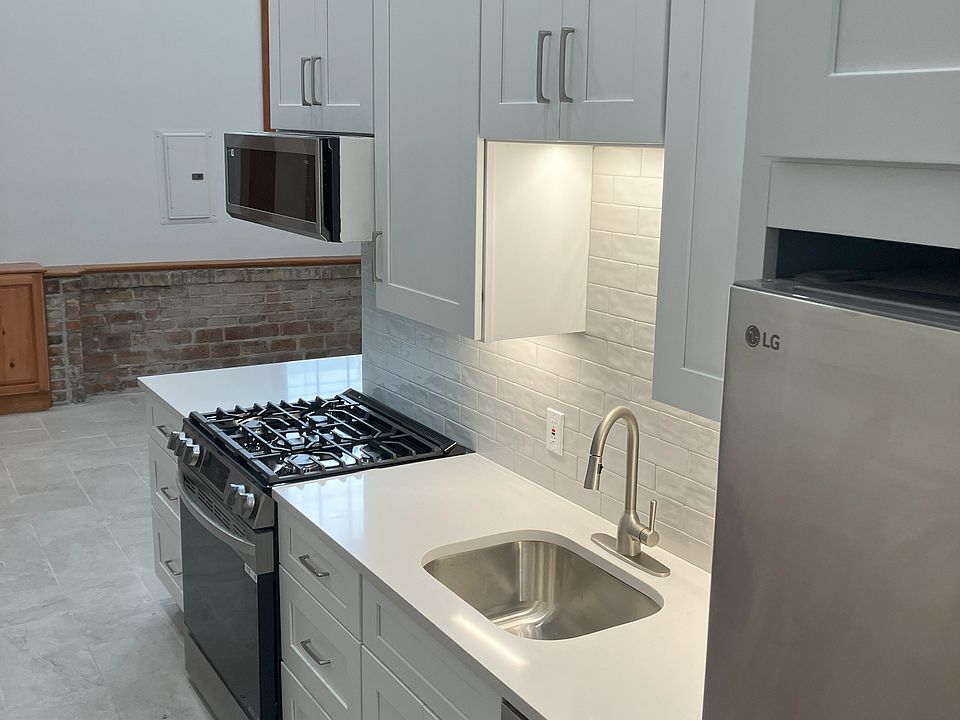 Brand new kitchen renovation with New appliances, including, microwave, stove, refrigerator and washer dryer