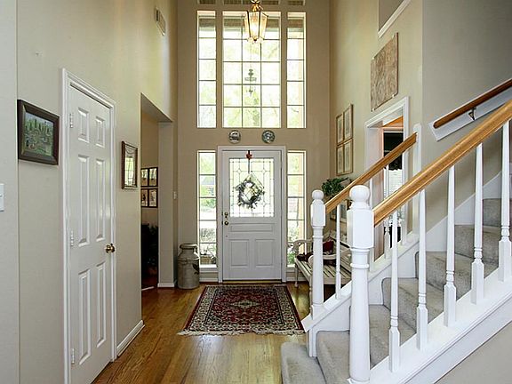 HIgh ceilings and lots of windows in the foyer fills the home with natural light.
