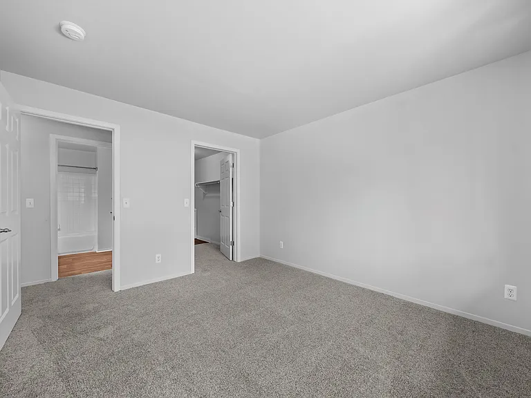 Spacious bedroom with ample storage space at Woodland Villa Apartments in Westland, MI.
