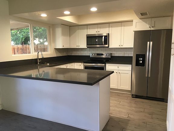 White kitchen, quartz countertops, wood-look tile