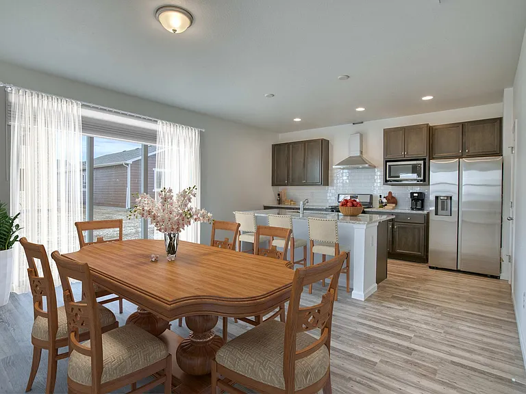 Dining and kitchen staged