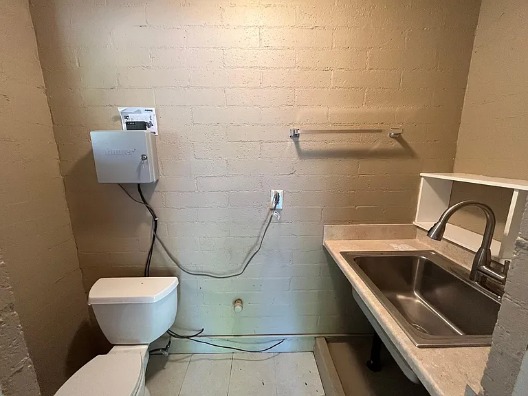Detached two-car garage features a convenient restroom with a utility sink, walk-in storage closet and automatic door opener. A large creative workshop space is connected to the garage.