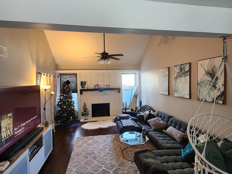 Main Living space with white fireplace and electric heating herth. Vaulted ceilings