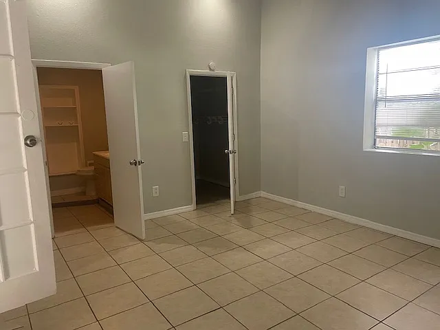 Primary bedroom with ensuite bathroom off foyer