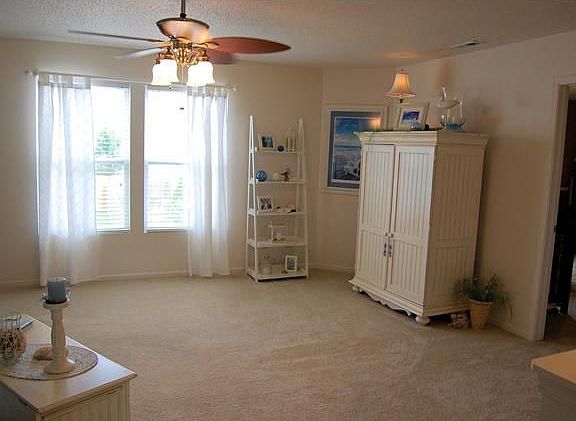 Another view of the spacious loft with ceiling fan.