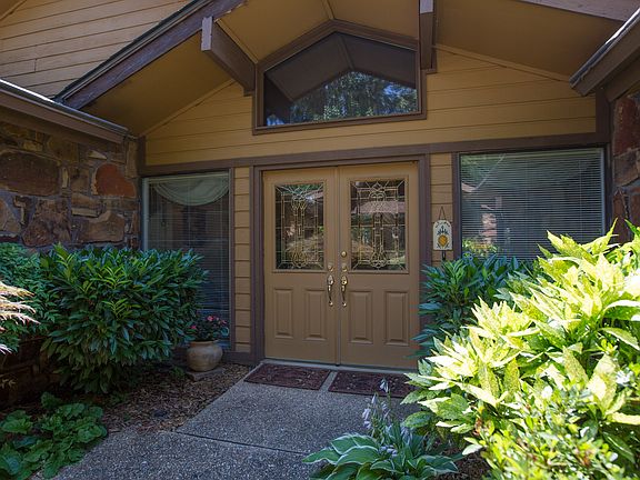 Courtyard-inspired Entry boasts double doors flanked by twin picture windows.