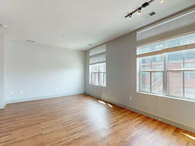 Apartment living room with wood-style flooring.