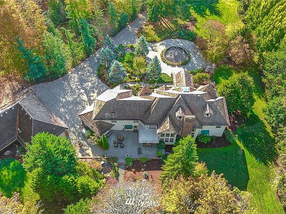 The drive circles up around to the pond and water feature to the stately brick adorned residence reminiscent of a European Castle. 