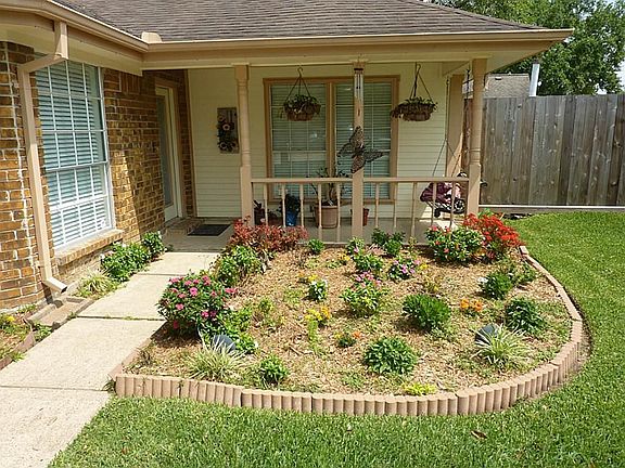 Pretty landscaping leads to covered front porch and entry to this 3 bedroom, 2 bath home.