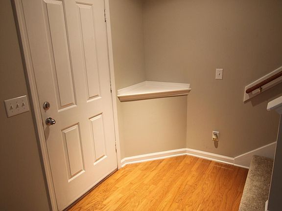 Bright entryway leading into the open living room and immediate access to upstairs bedrooms