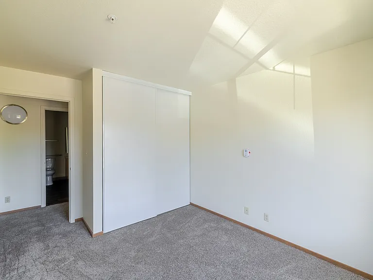 Bright bedroom retreat with generous closet space and soothing natural light.