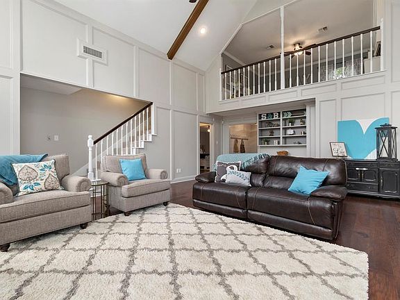 Look at that open ceiling and balcony to the upstairs. This room could not be more full of character and warmth.
