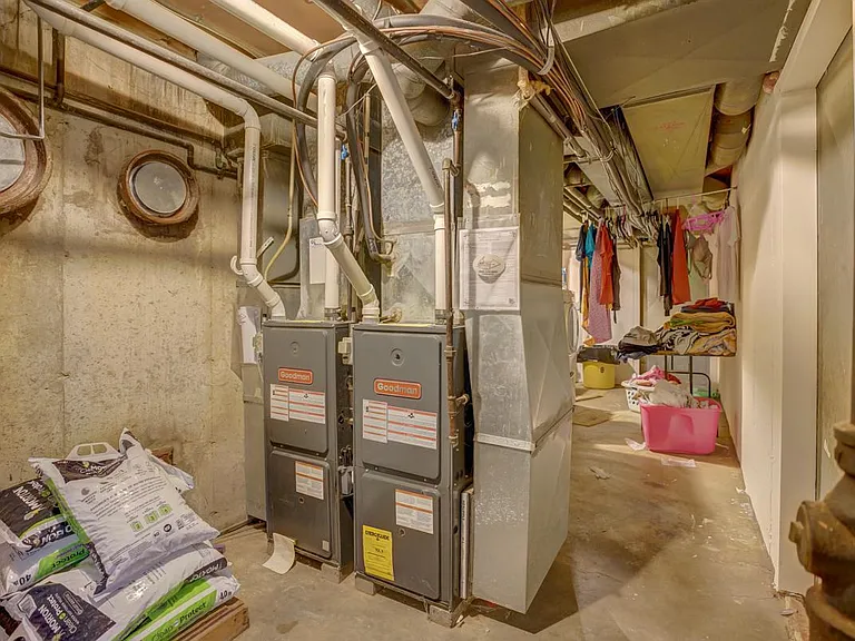 Shared mechanical room space. Each unit has their own furnace, water heater, and water softener