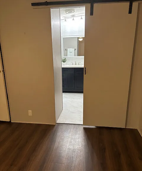 Master Bedroom: Newly painted with new Ceiling fan/light. Barn door leads to master bathroom.