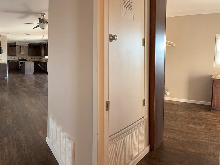 wide view of hallway to laundry room and rest of house