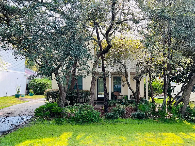 Trees lining the front make the house feel secluded and private