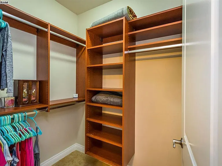 Master closet with built in storage areas.
