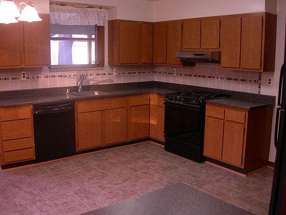kitchen new floors, fridge, dishwasher countertops tile backsplash