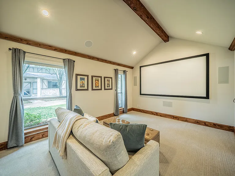 Movie Night Haven: Large Projection Screen, Wood Beams & Cozy Sofa