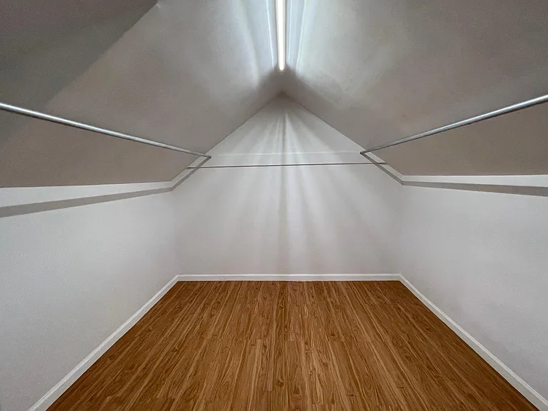 Upper level walk in closet. Large enough to be used as office space.