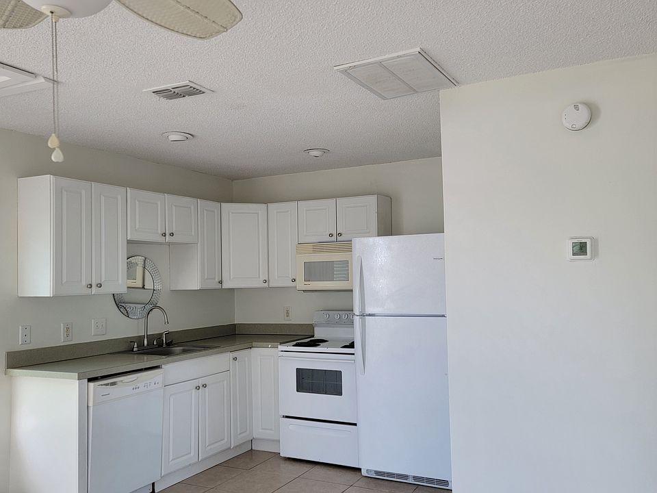 Kitchen with dishwasher, oven, microwave, and refrigerator. Tile flooring throughout!