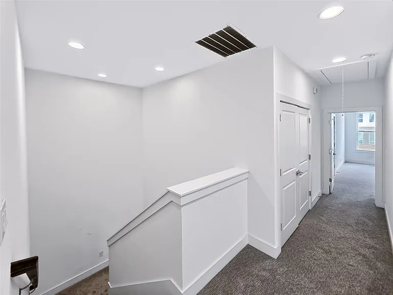 Upper-level hallway featuring recessed lighting, a neutral color palette, paneled doors, and gray carpeting