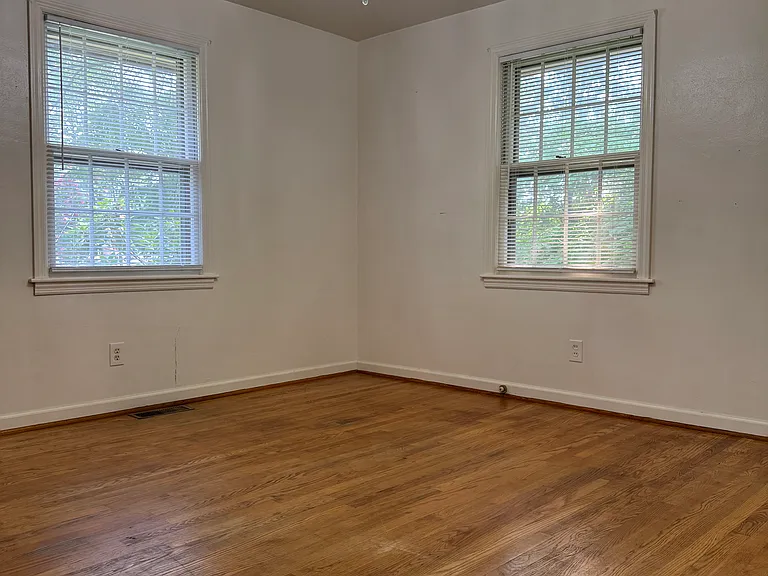 Bedroom #1. Has hardwood floors, two windows, and a nice size closet with two sliding doors.