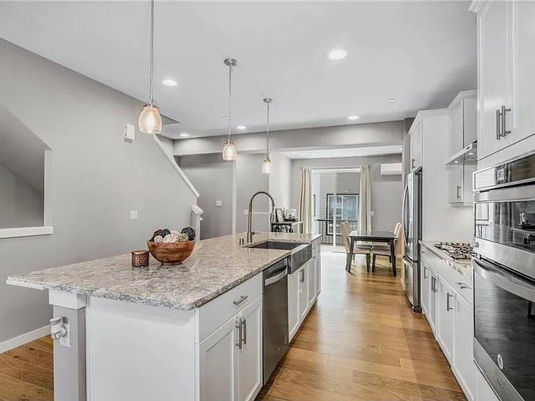 The open concept main floor has upgrades to kitchen cabinets, counters, hardware, and appliances. Enjoy the large open dining area that leads to your own private patio with a grill for your outdoor BBQ.
