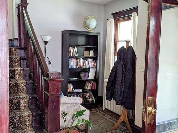 The entry-way can be used as a welcoming space, a piano room, a small library, or a study. The stairs lead to the bedrooms upstairs.