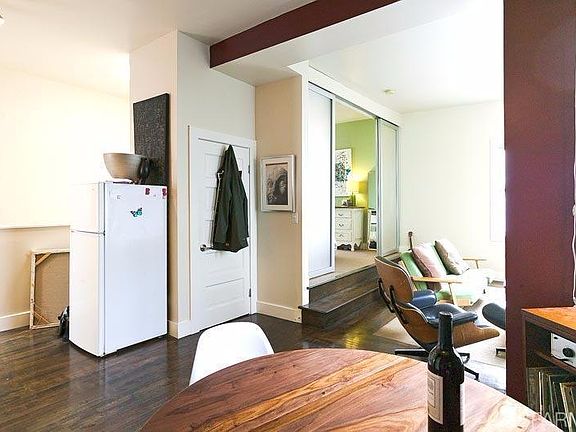 dinging area into living room as furnished by last tenant