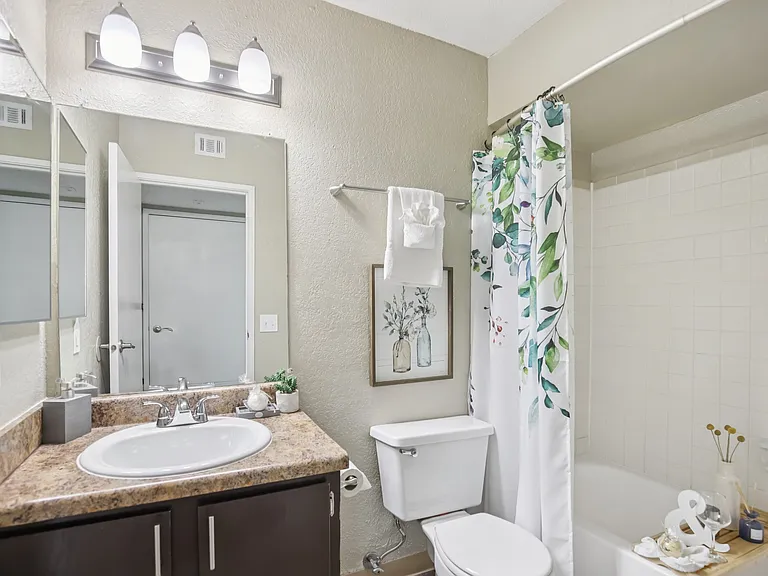 One bedroom bath with tile surround.