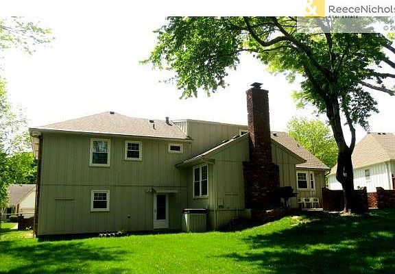 View of back side of the treed, fenced yard.